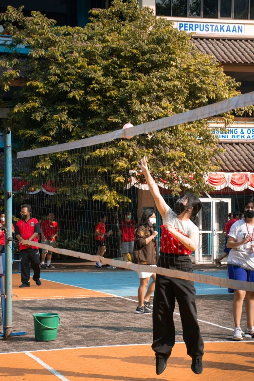 a volley ball player jumps to hit the ball