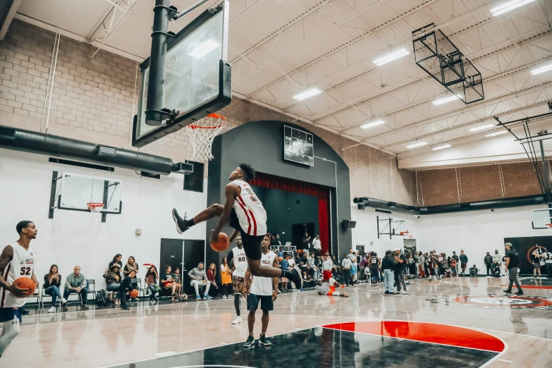 basketball player jumps to dunk in the air over the net