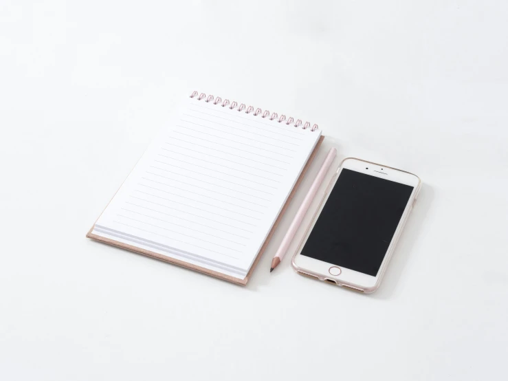 a note pad and an open samsung galaxy s6