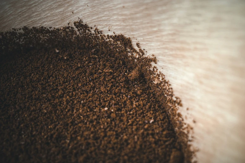 a large mound of dirt next to a river