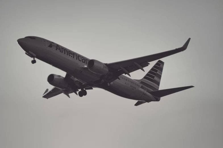 a large passenger jet flying through a cloudy sky