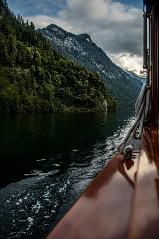 a view from a boat on a lake in the mountains