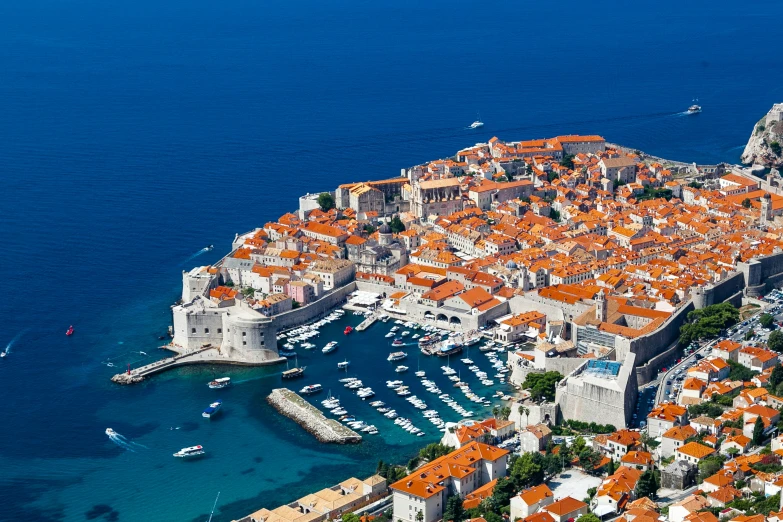 an aerial s of boats on a harbor with orange roofs