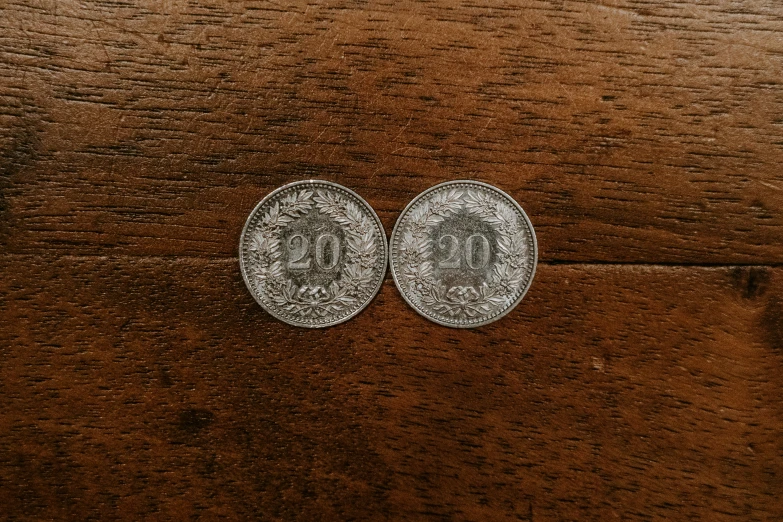 two coins placed next to each other on a table