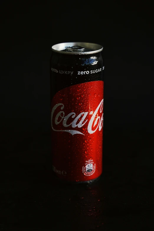 a coca - cola can with rain droplets on the surface