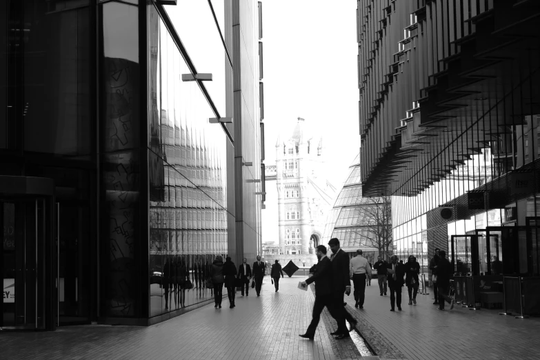 black and white pograph of people on sidewalk