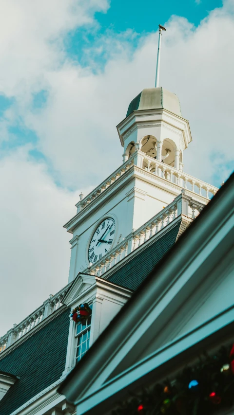 a tall white clock tower on top of a building