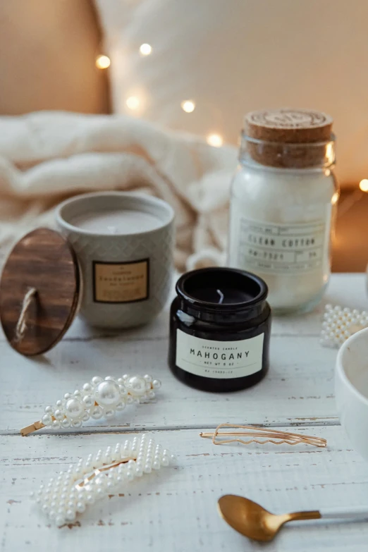 a set of items for makeup and pearls sitting on a white table