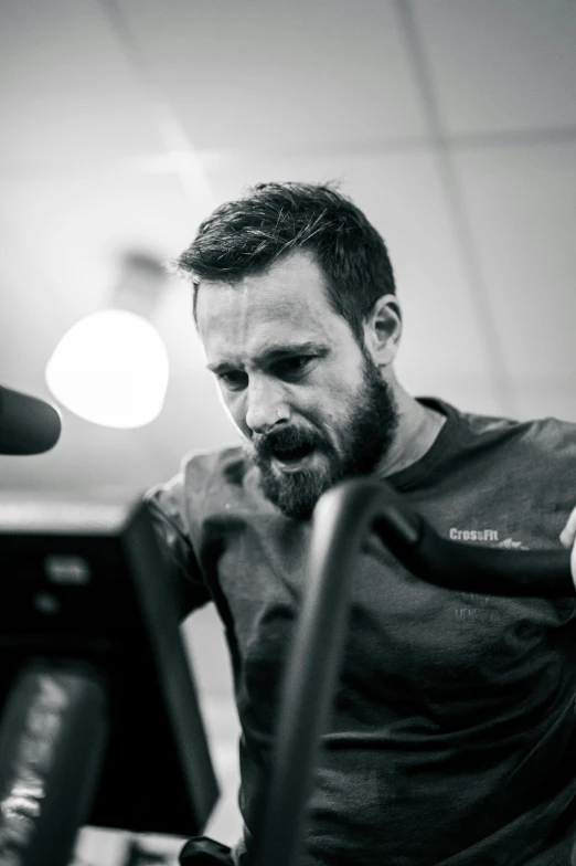 a man sitting at a desk while typing on his cell phone