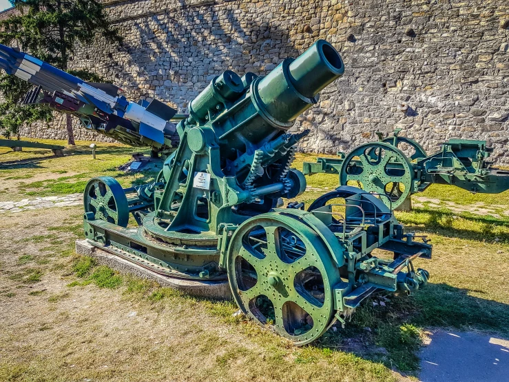 a large metal cannon sitting in the grass