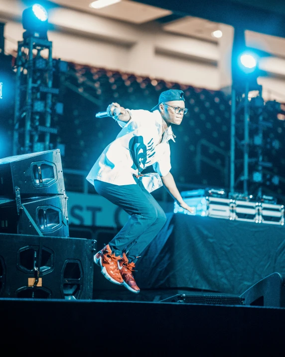 a person jumping off a stage while standing on a stage