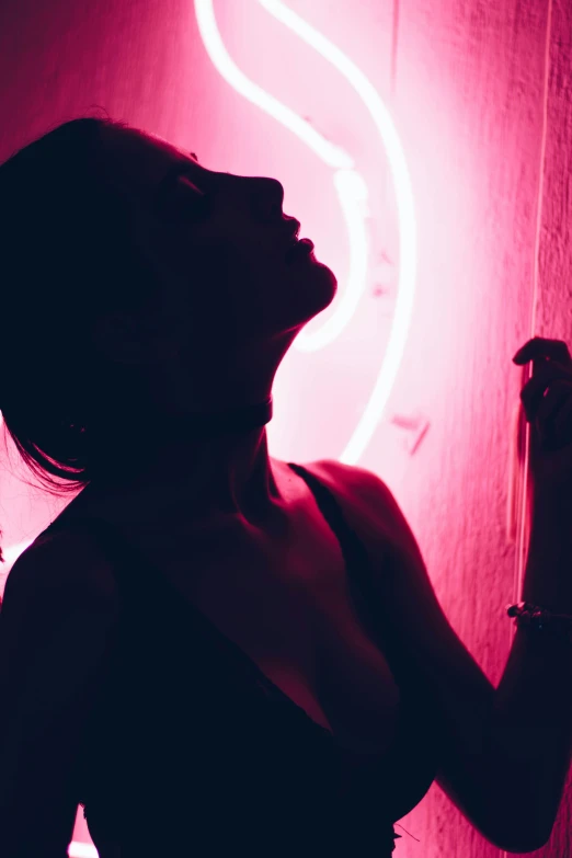 a woman in a dark room with neon lights