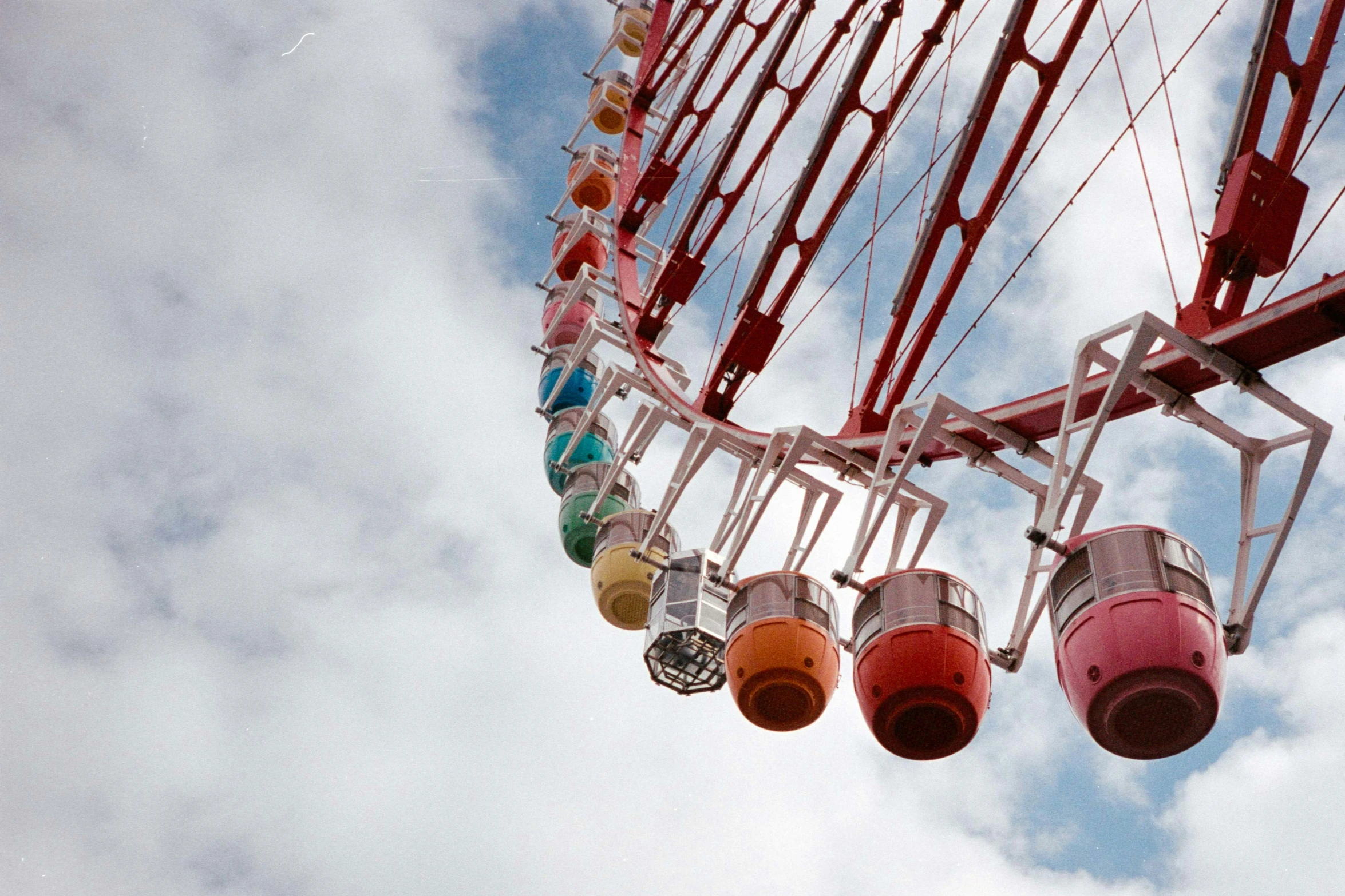 there are several colored ferris wheels in the sky