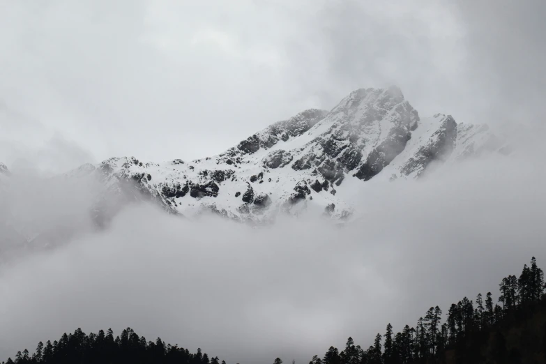 some clouds cover the tops of mountain peaks