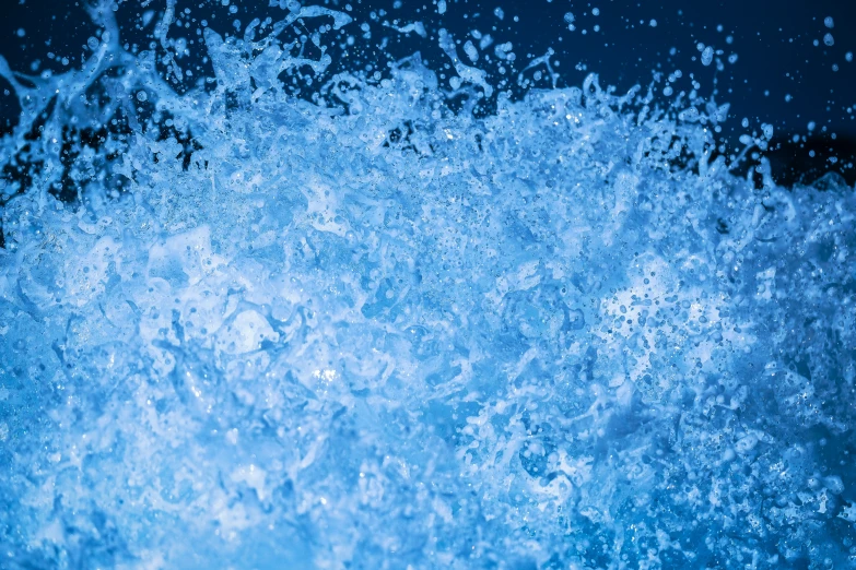 a blue colored liquid pouring on to a surface