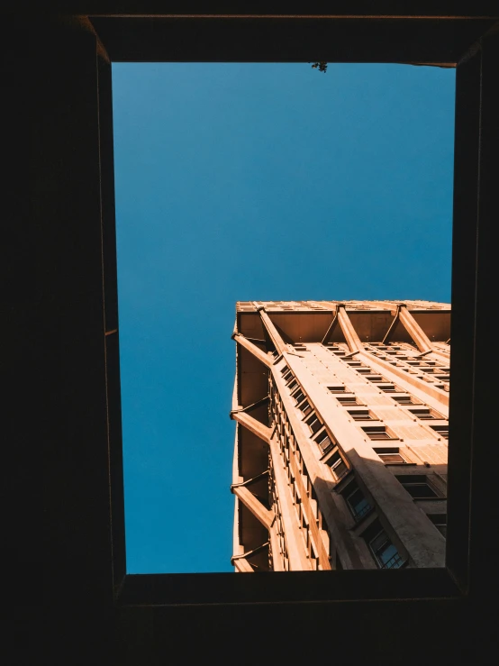 a tall building standing through a window