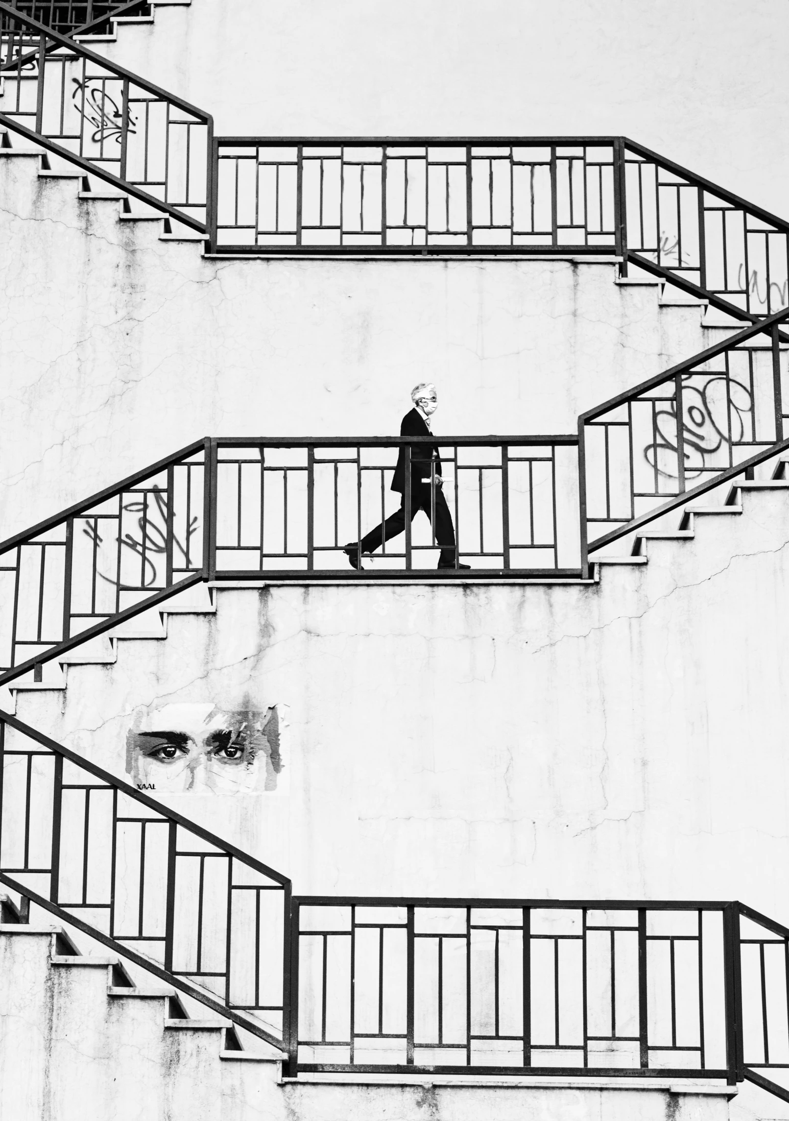 black and white pograph of people walking up a set of stairs