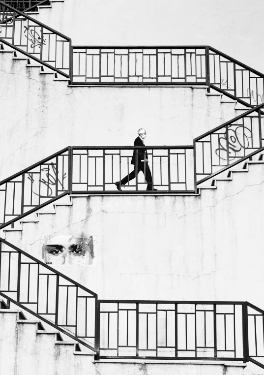 black and white pograph of people walking up a set of stairs