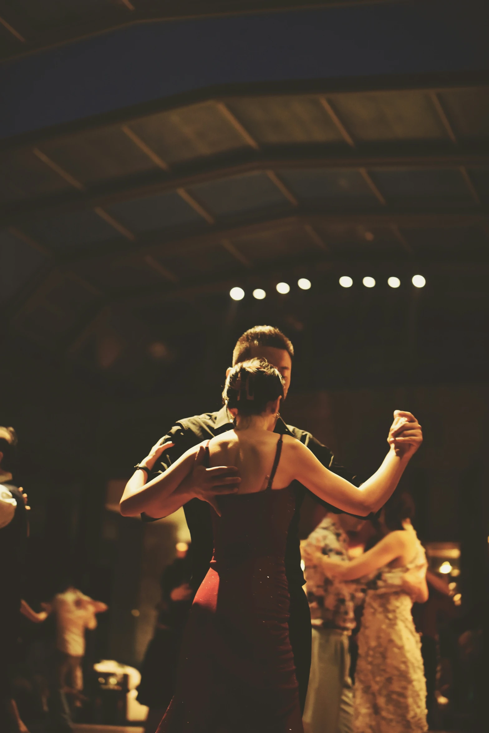 a woman in black dress on stage dancing