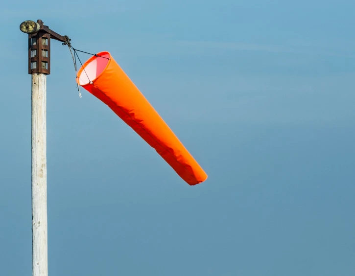 a person holding a big red object that looks like an orange flag