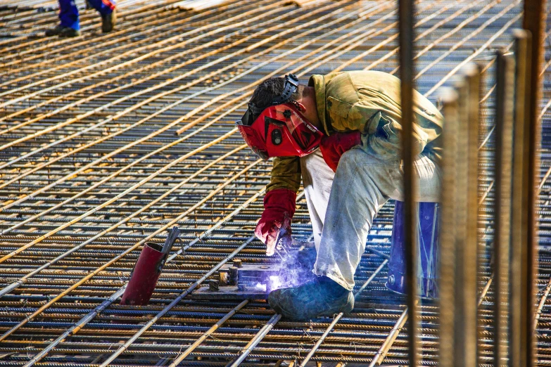 a man kneeling down on a metal floor