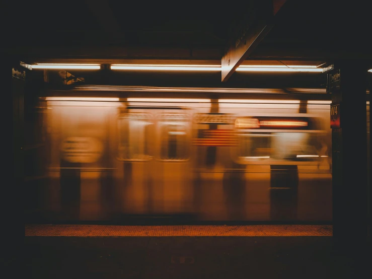 a train speeding by on the night of a very blurry picture