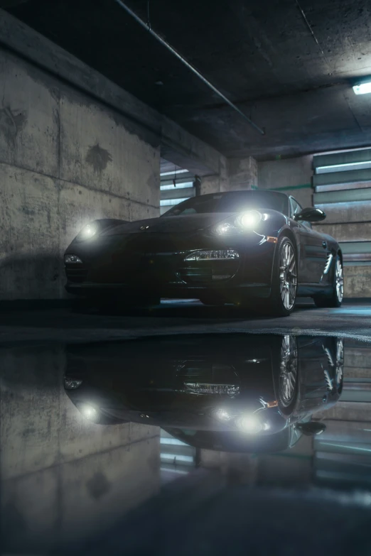 a car is reflected in the water of a dark room