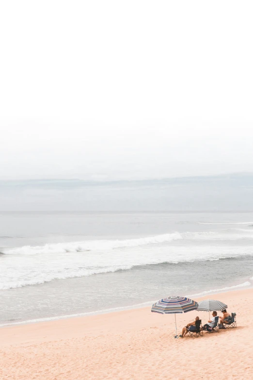 umbrellas and sunbathers lay on the beach in the afternoon