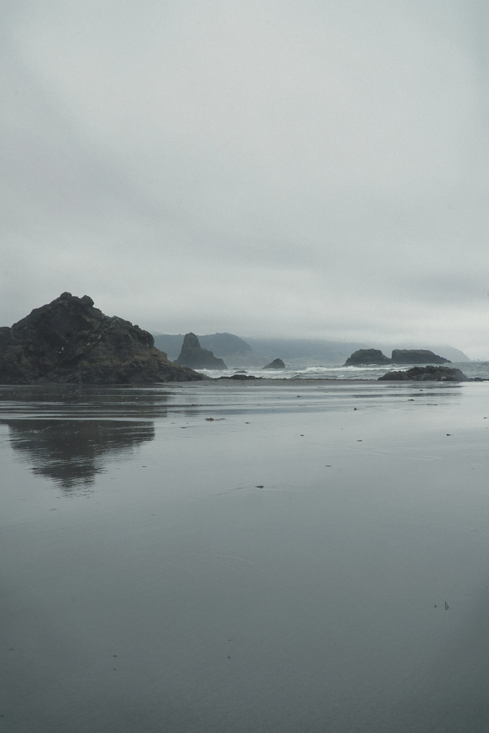 a landscape po of two rocks in the water