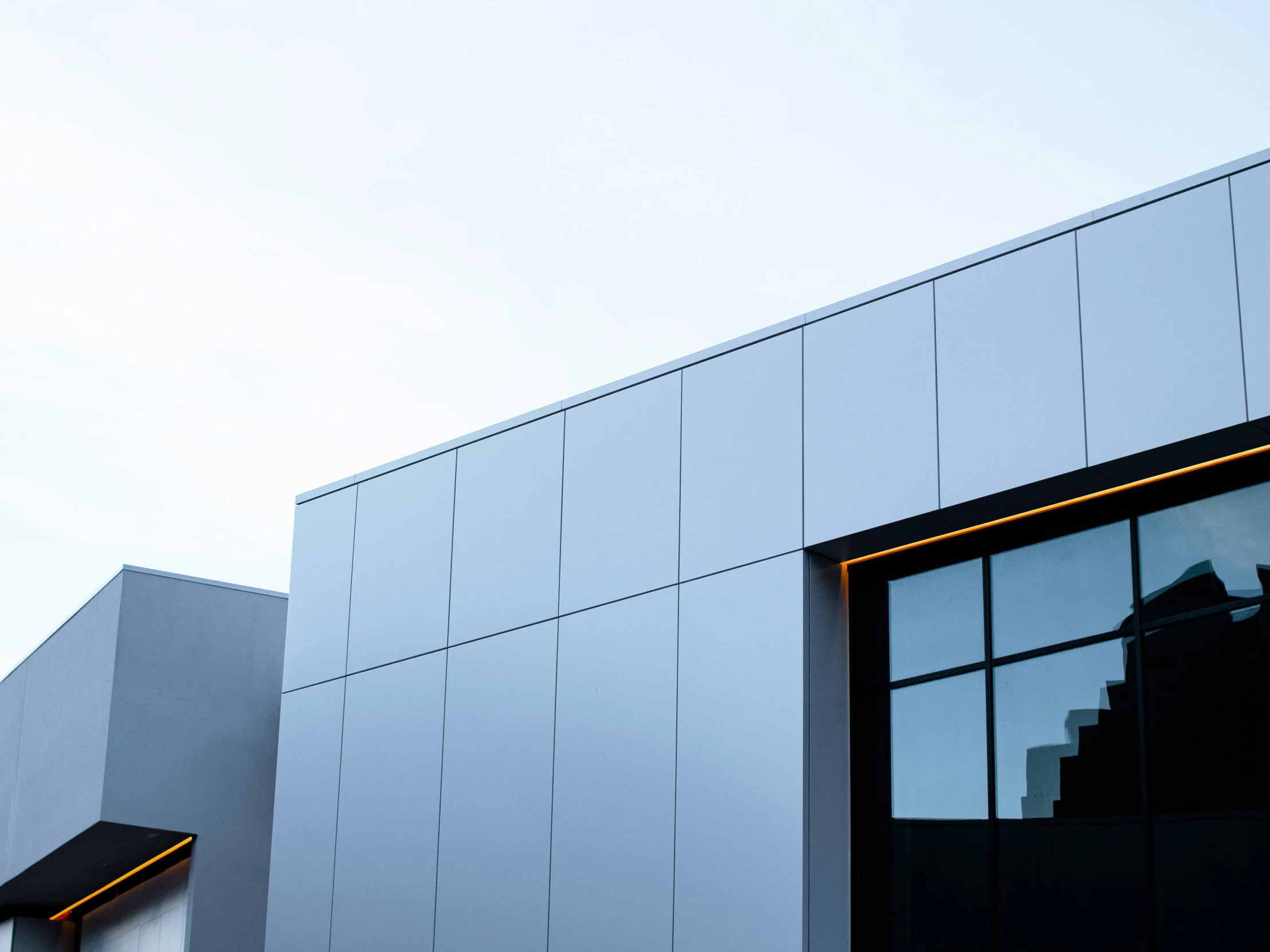 some windows and the side of a building with a clock