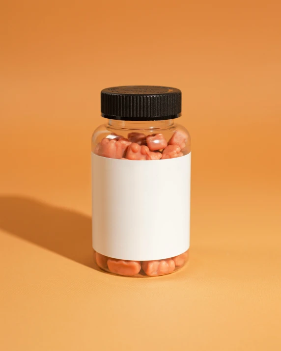 a small glass jar filled with pill like things