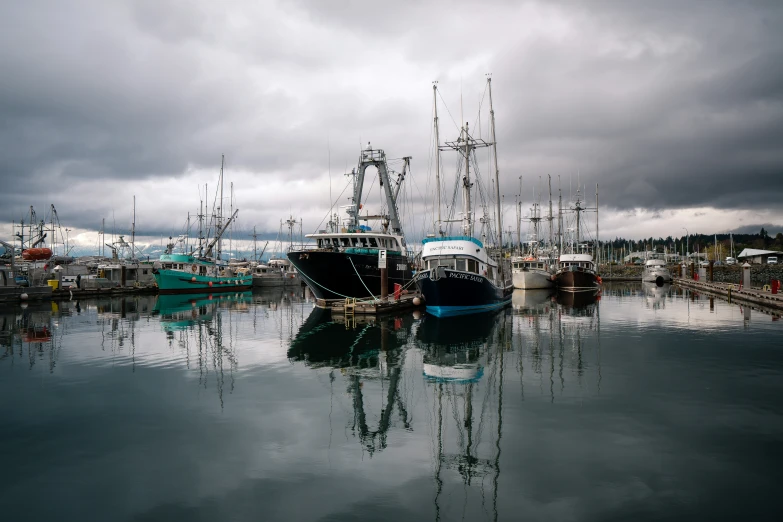 some very big beautiful boats docked in the water