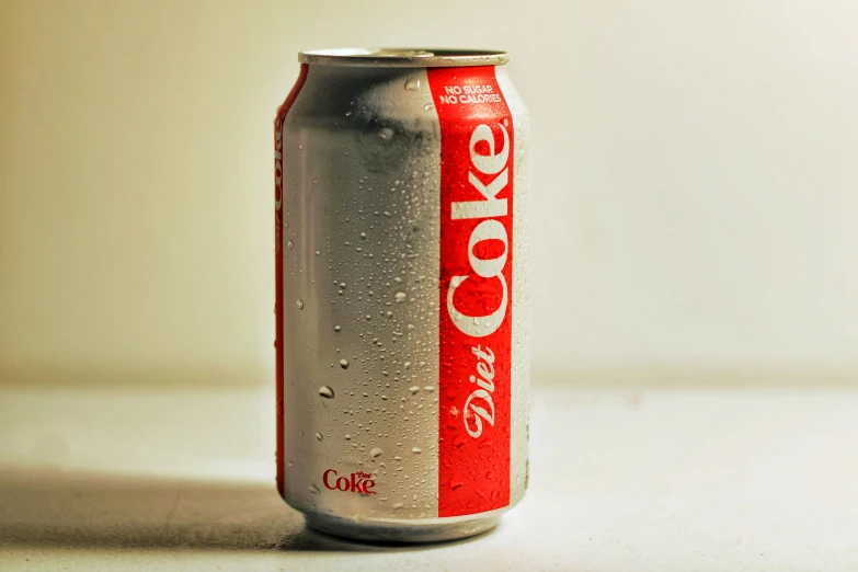 an empty coke can sitting on a white counter