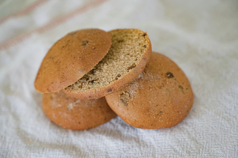 a close up of three small cookies on a white surface