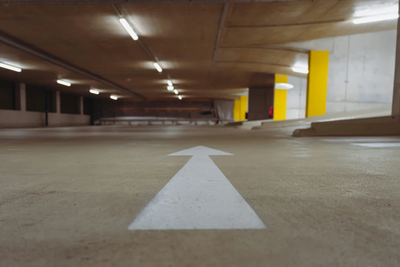 an empty parking lot with a yellow column