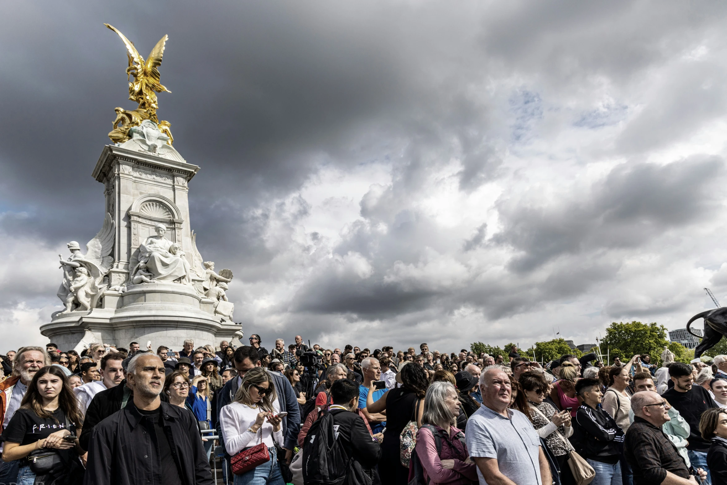 people standing around and looking at a monument