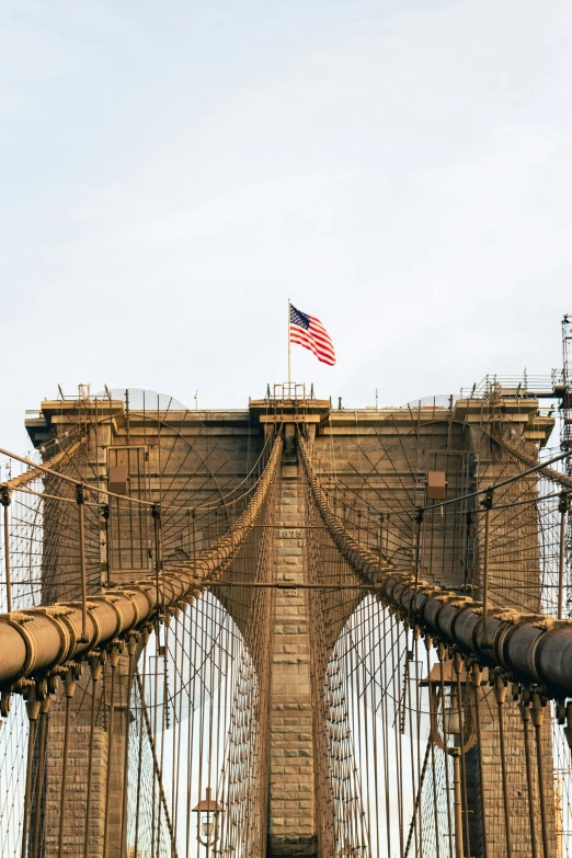 a view of the side of a bridge that has cables going across