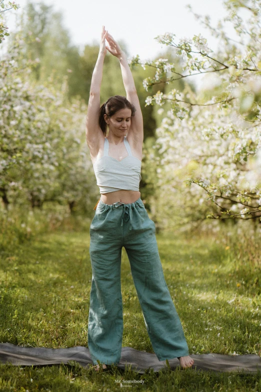 a woman doing yoga exercises in a field