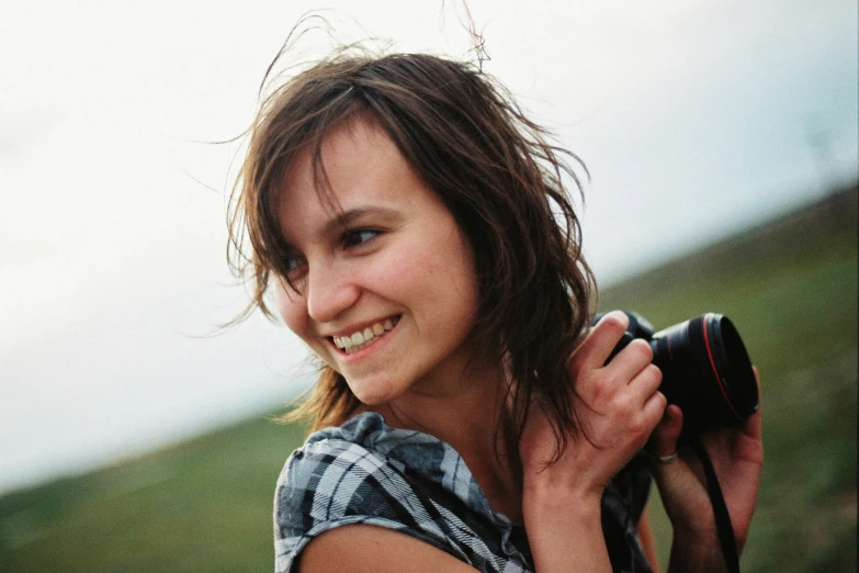 a young lady taking a picture with her camera