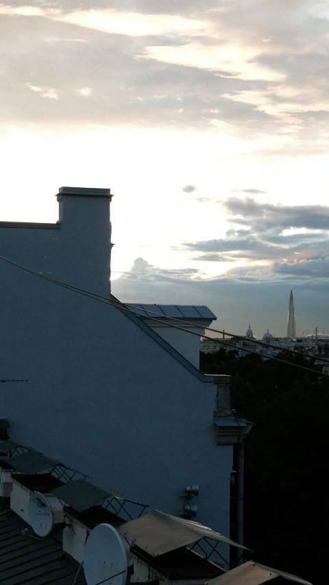 rooftop top view of city in distance during a cloudy day