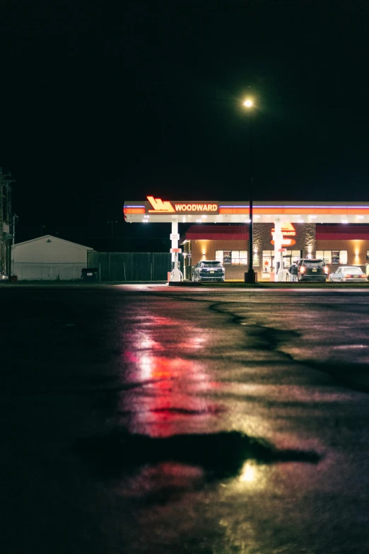 the cars are parked in the lot outside of the gas station