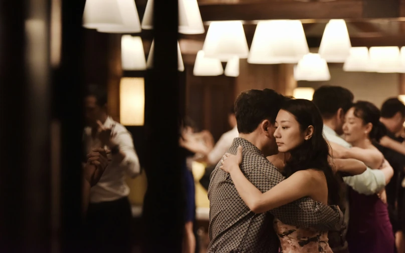 an asian couple dancing on their belly and arms