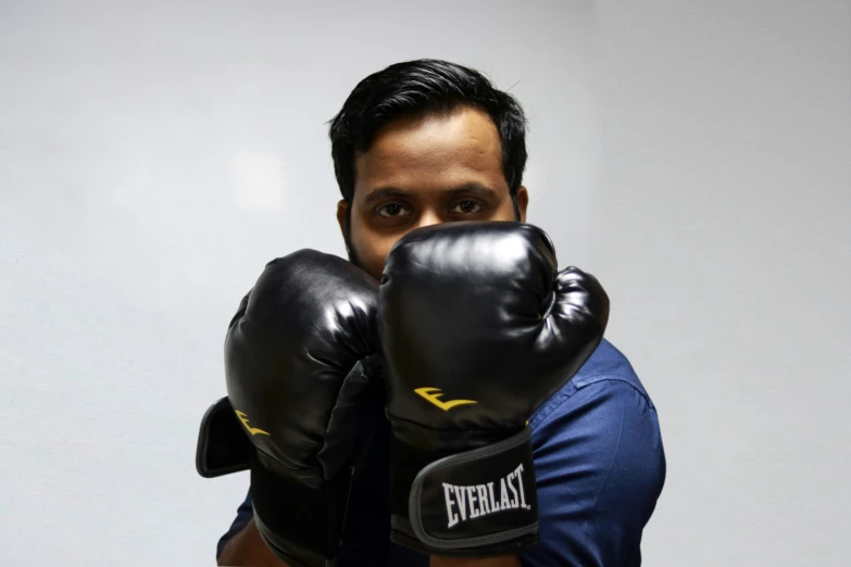 a man wearing boxing gloves over his mouth