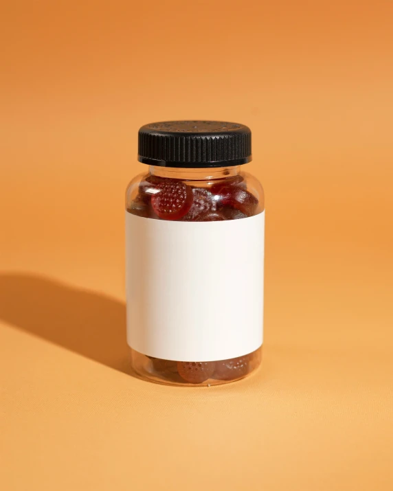 a jar of raspberry jam with a black lid