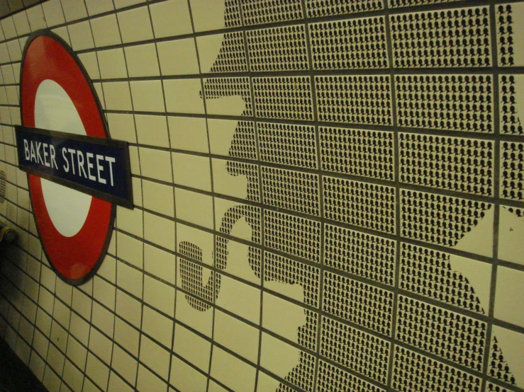 a large sign and some wall paper in a train station