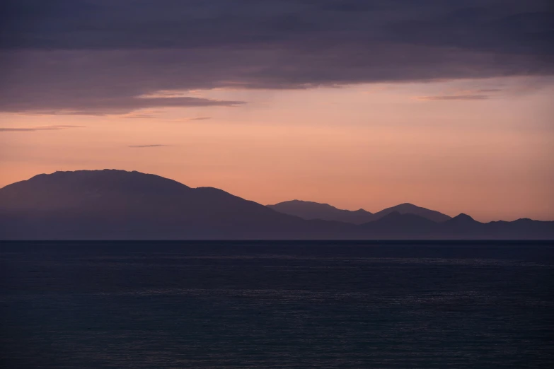 a couple of large mountains on top of the ocean