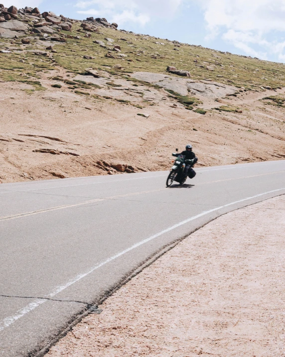 a motorcycle driver is on the side of a highway