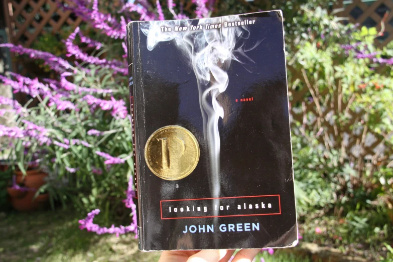 a person holding a book titled, smoking for africa