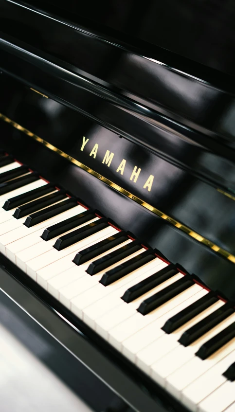 a black piano has the word yamaha written on it