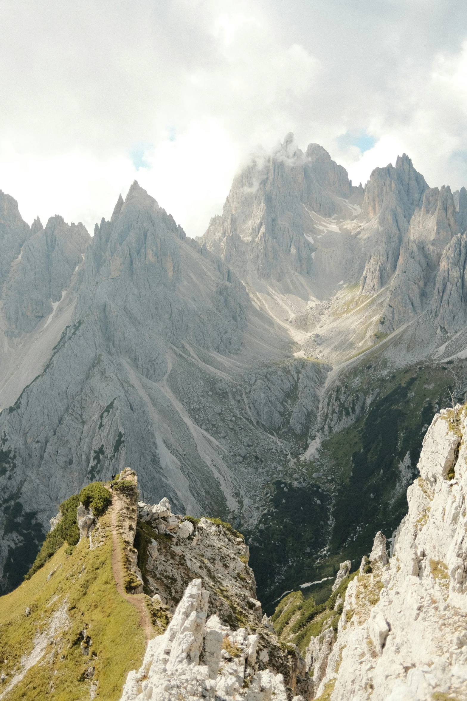 a mountain landscape with very high hills and clouds